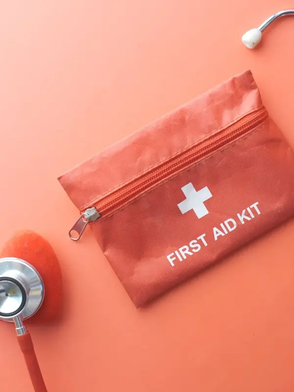 Red first-aid kit next to a stethoscope