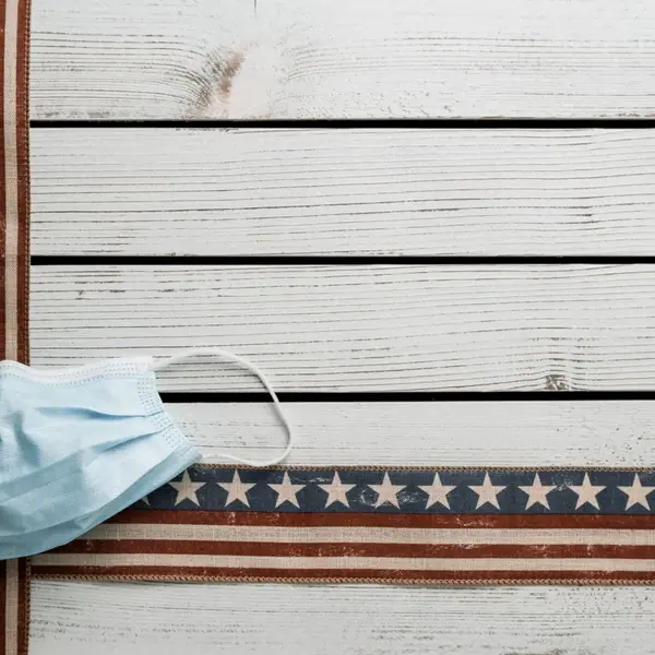 Face mask on white wooden boards